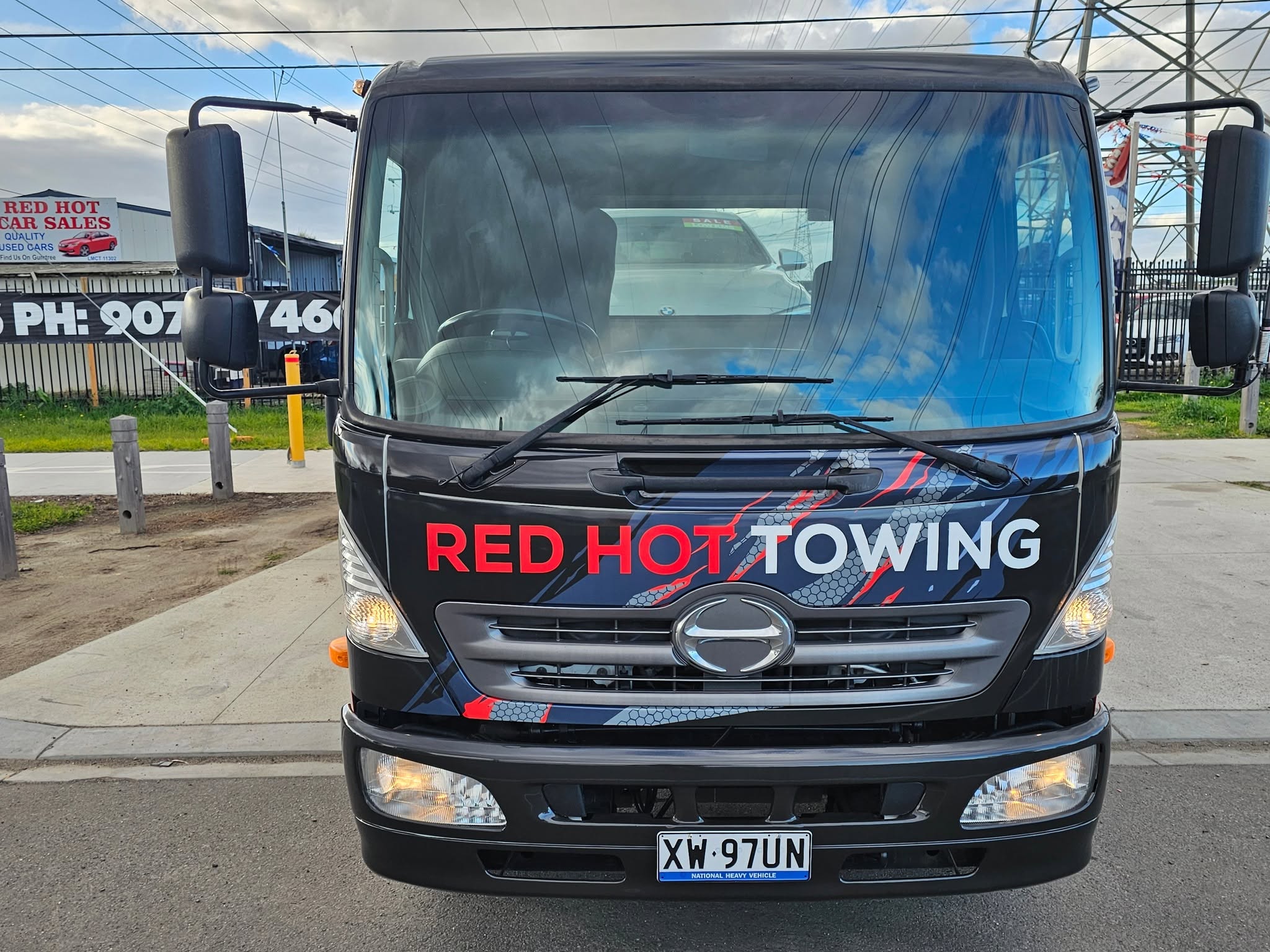 Close-up of the Red Hot Towing cab signage and tow arm decal