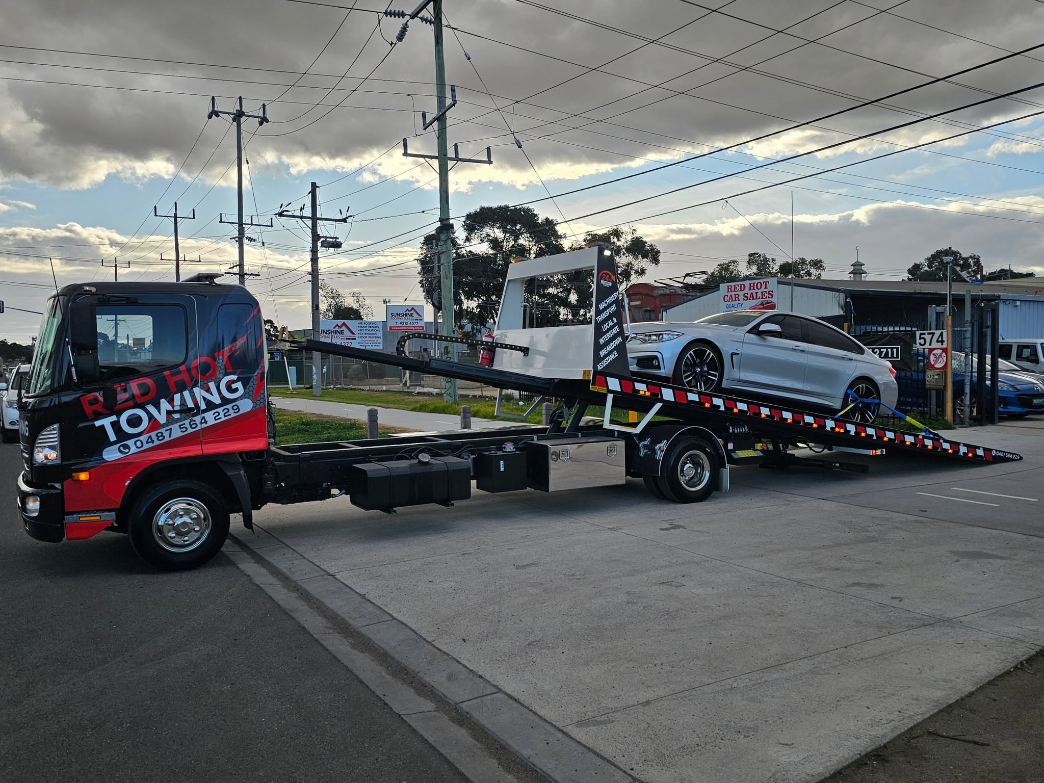Front view of the Red Hot Towing truck showing the wordmark livery
